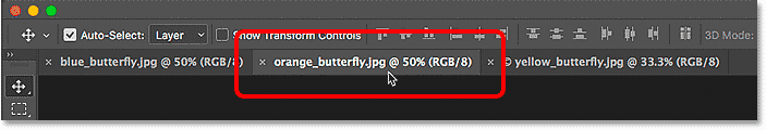 Selecting the middle document tab in Photoshop.